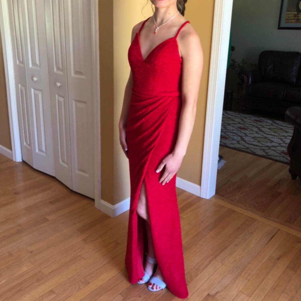 Sparkly red Jovani prom dress. It is a size 2 and has a slit on the left leg.